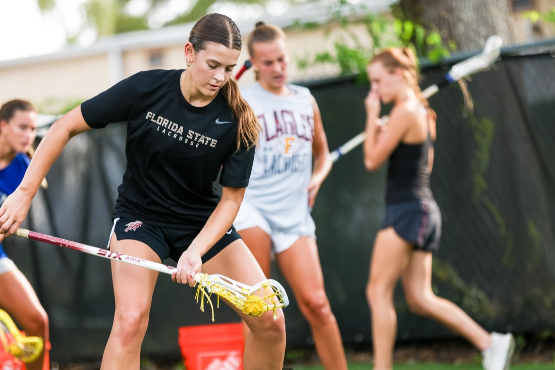 Lacrosse player scooping a ground ball during a BCP Lacrosse session