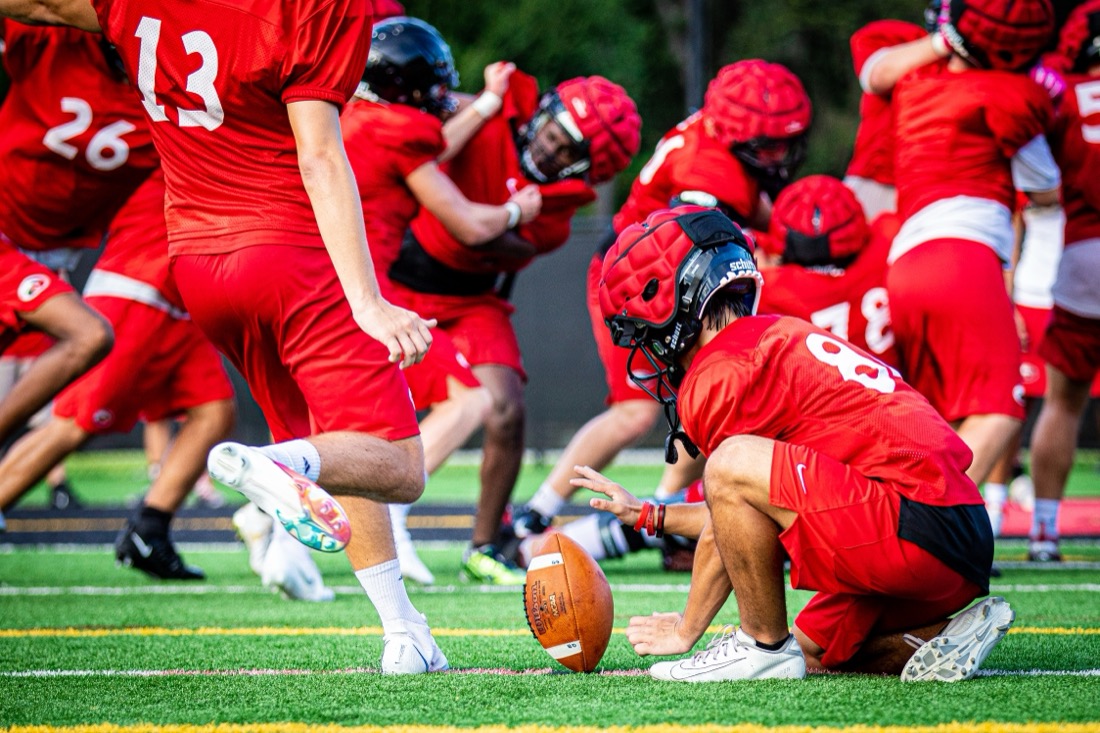 Players working through contact drills at a preseason football practice